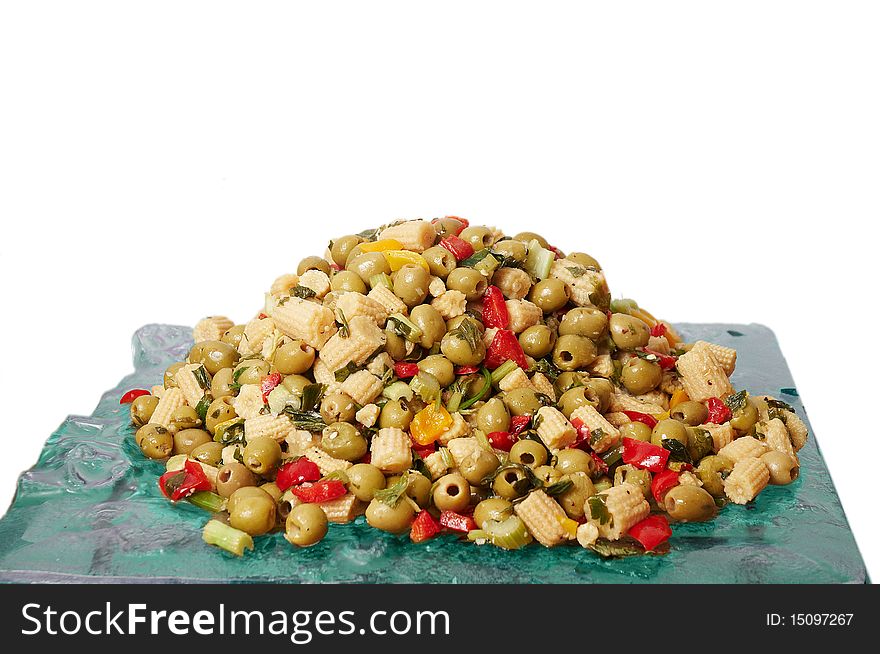 The dish with a salad of pickled corn and olives isolated on a white background. The dish with a salad of pickled corn and olives isolated on a white background.