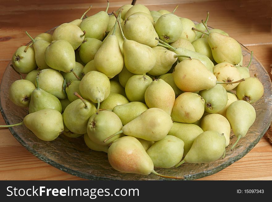 Vase with Pears on the background of a wooden table. Vase with Pears on the background of a wooden table.