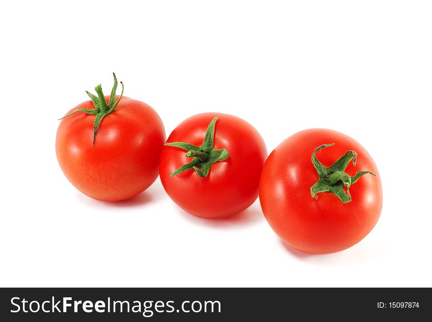 Three tomatoes are isolated on a white background