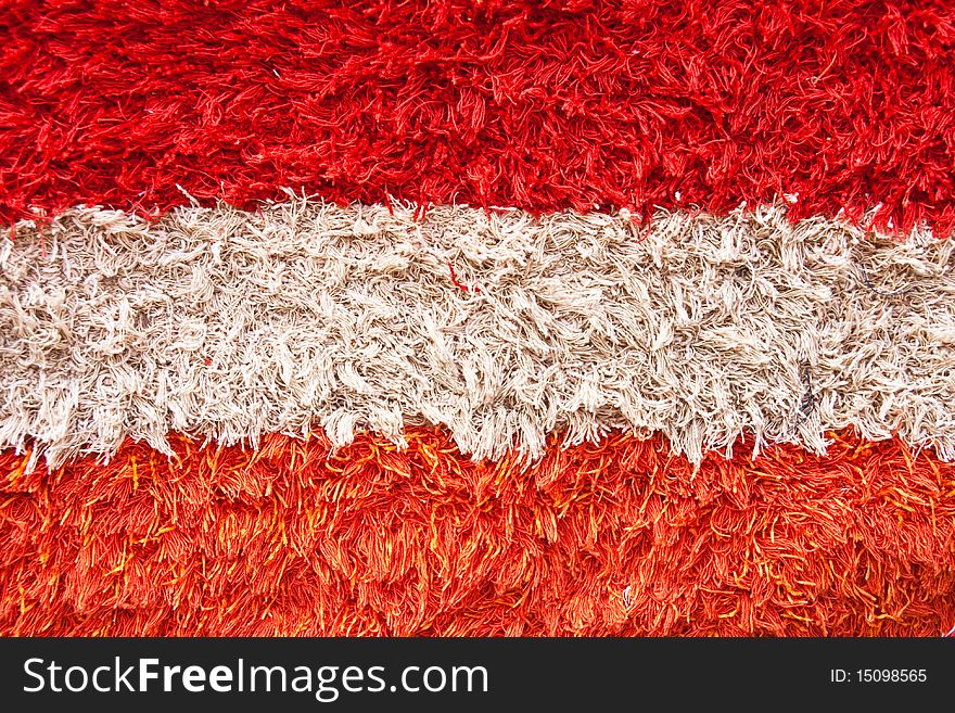 Close view of carpet texture colored on white and red