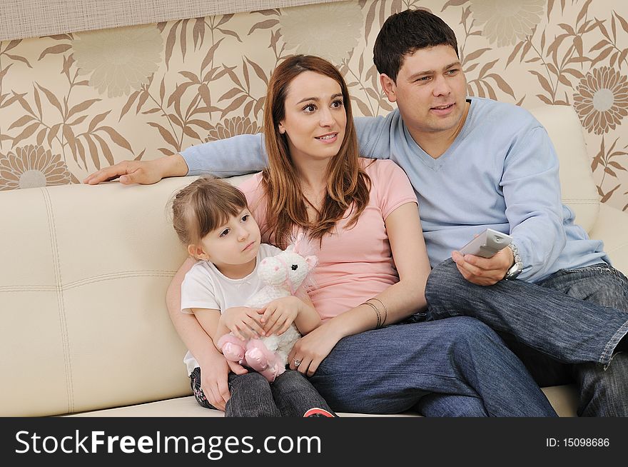 Happy youg family relaxing in modern livingroom at home. Happy youg family relaxing in modern livingroom at home