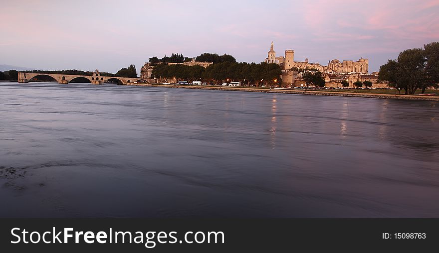 Avignon landmarks, Palace of the Popes and Pont Saint-BÃ©nezet, seen across the river Rhone at sunset. Avignon landmarks, Palace of the Popes and Pont Saint-BÃ©nezet, seen across the river Rhone at sunset.