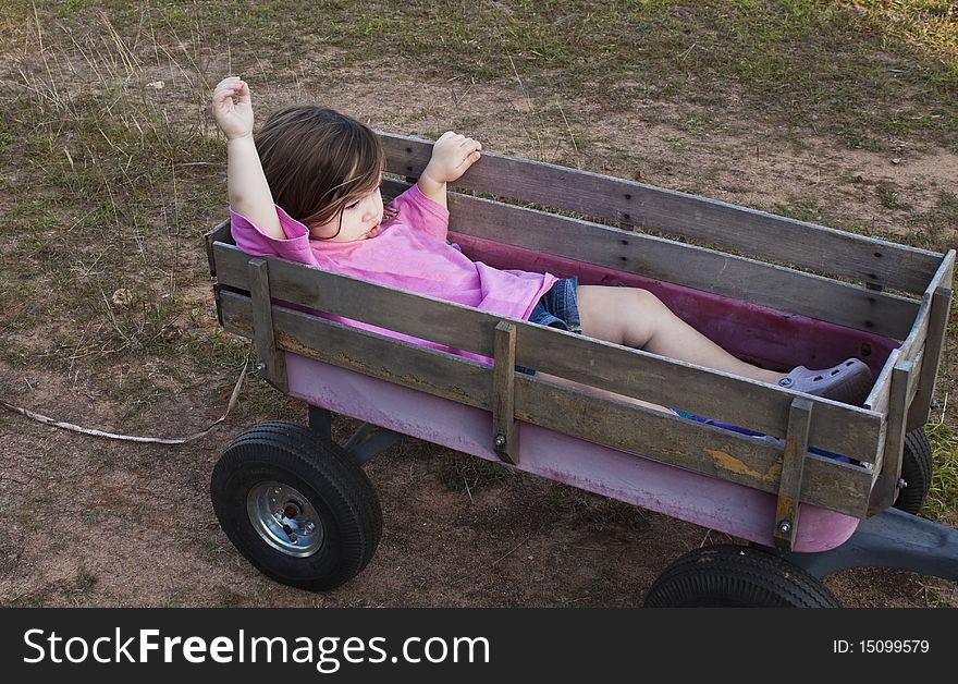 Girl in a wagon showing frustration