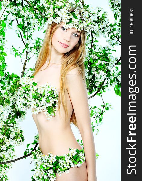 Portrait of a beautiful spring girl in apple tree flowers. Portrait of a beautiful spring girl in apple tree flowers.