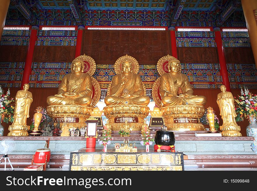Three big golden buddha in chinese temple. In Thailand.