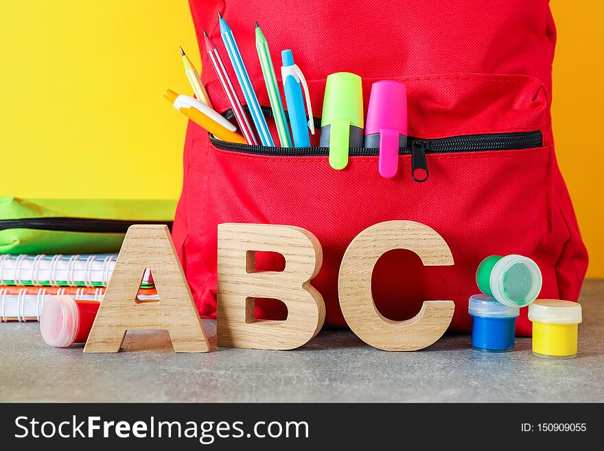 School supplies on grey table against color background, space for text