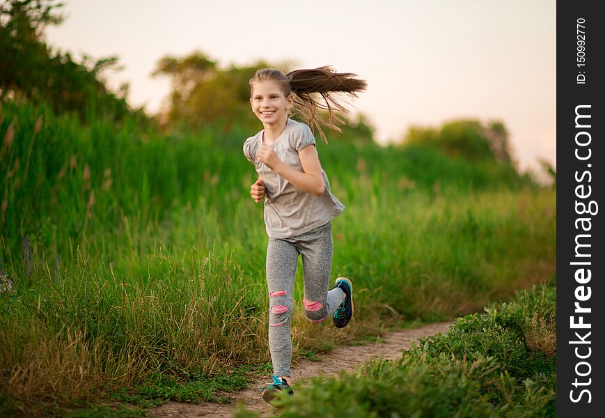 Little cheerful girl running, playing sports