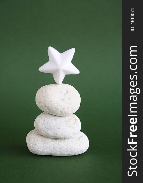 White pebbles and star with green background. White pebbles and star with green background