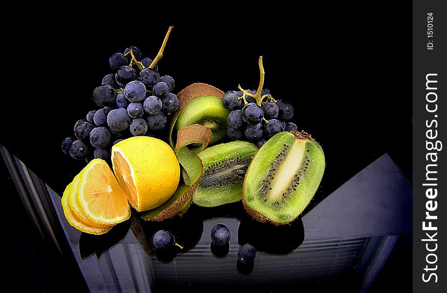 Fruit of different colours on a black background. Fruit of different colours on a black background.