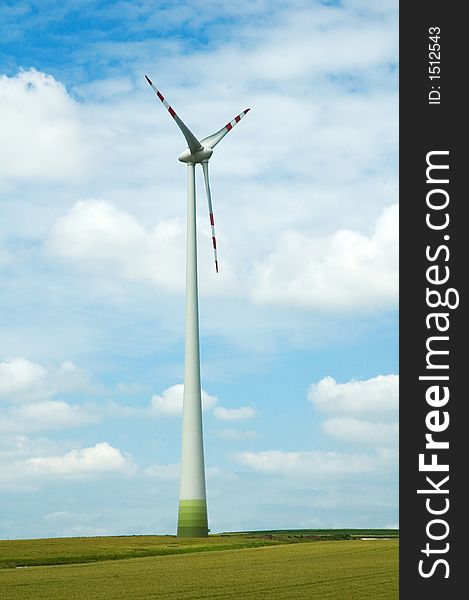 Large energy windmill standing in green summer field. Large energy windmill standing in green summer field