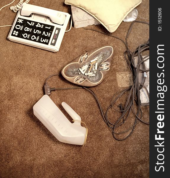 Ashtray, phone, and urine jug on floor. Ashtray, phone, and urine jug on floor.