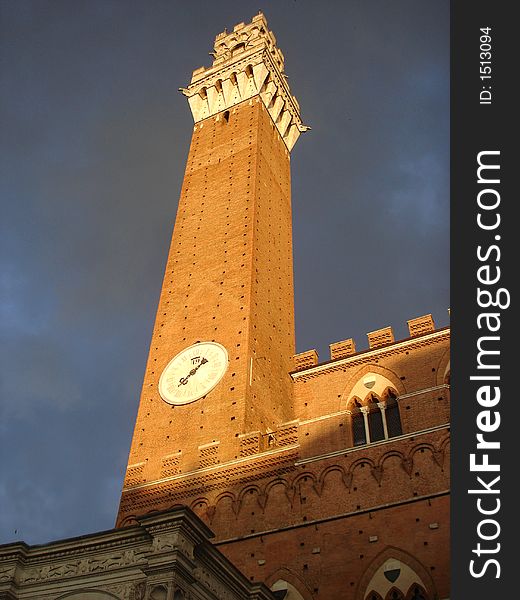 Afternoon of a stormy day in Siena. Grey-violet clouds contrast with the brick walls of Palacio Buensignori. Afternoon of a stormy day in Siena. Grey-violet clouds contrast with the brick walls of Palacio Buensignori.
