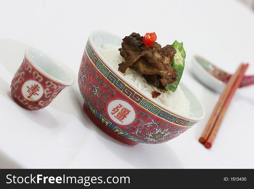Rice, meat and vegetable neatly packed in a small Chinese rice bowl. Rice, meat and vegetable neatly packed in a small Chinese rice bowl