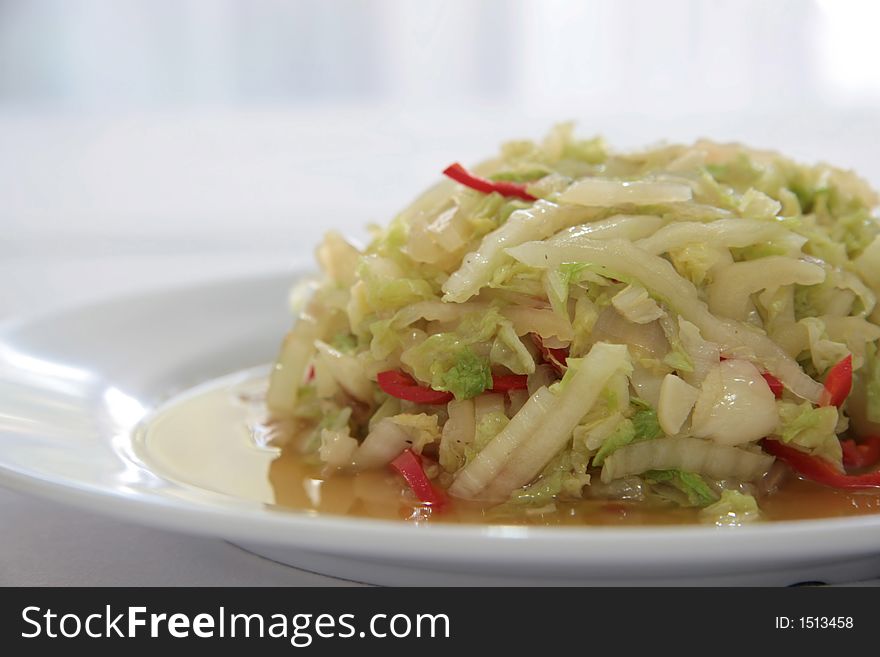 Chinese style fried thinly sliced cabbage strips with chili and onions. Chinese style fried thinly sliced cabbage strips with chili and onions