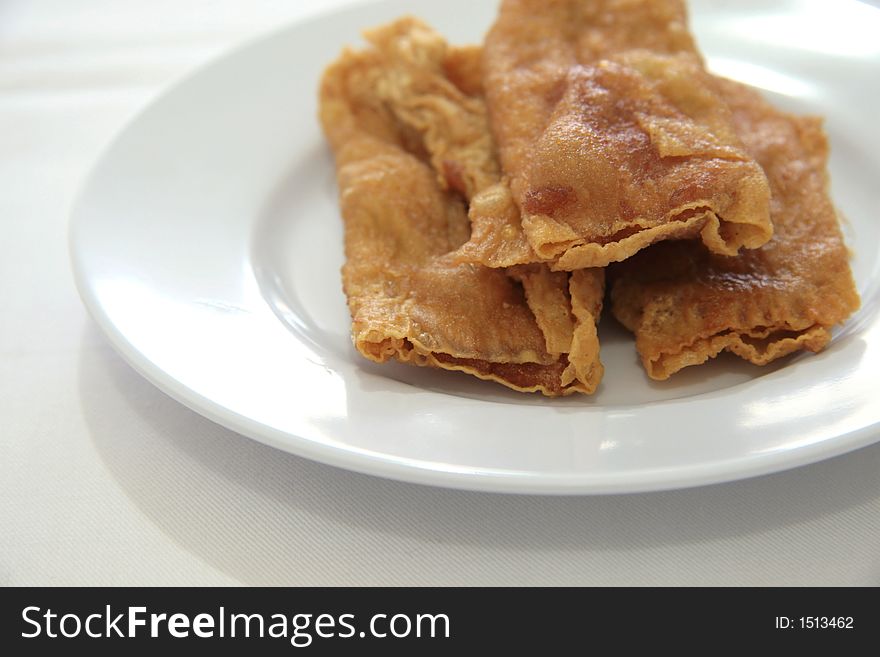 Deep fried flat spring rolls with boiled fish paste rolled in soy scum skin. Deep fried flat spring rolls with boiled fish paste rolled in soy scum skin