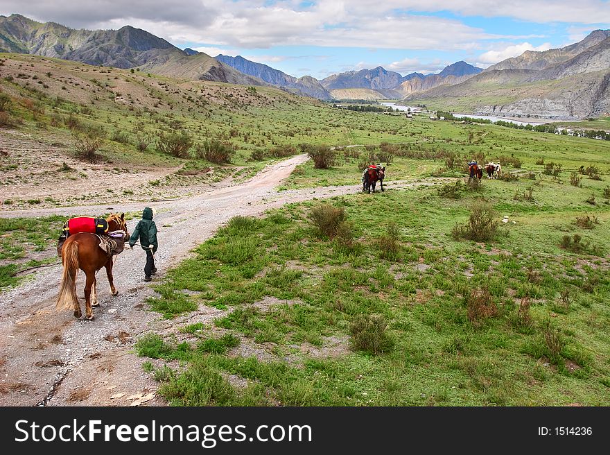 Road, mountains, horse and women.