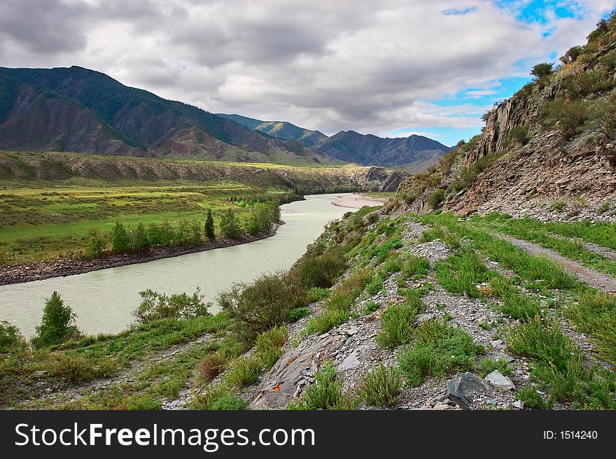 Road, mountains and river.