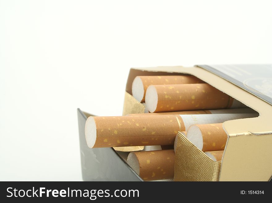 Cigarettes in packet against a white background