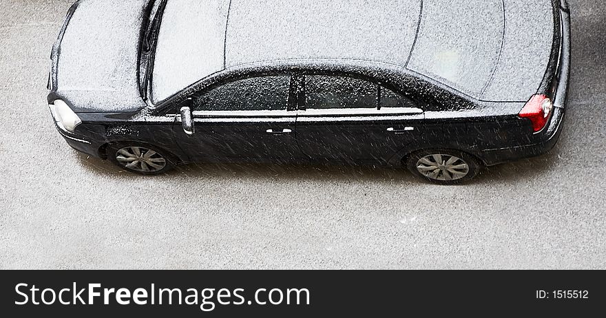 The automobile of a business-class covered by snow on a parking. The automobile of a business-class covered by snow on a parking