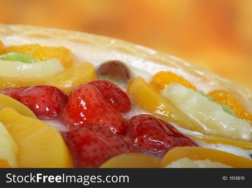 Summer garden fruits in a sweet glazed cream pie dessert, macro close up with copy space