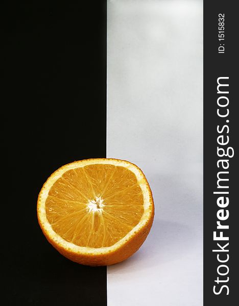 An orange put on a black and white background. An orange put on a black and white background.