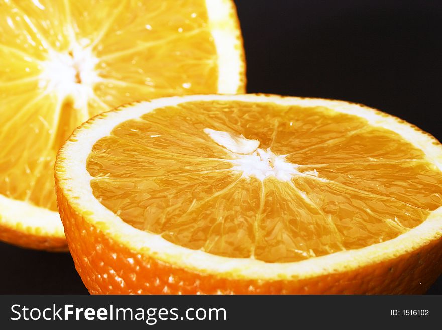 An orange cutted in two pieces. An orange cutted in two pieces.