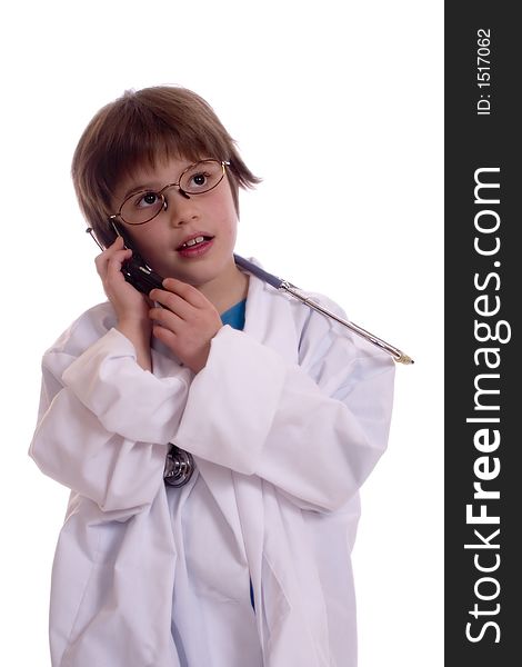 Adorable girl wearing lab coat with a stethoscope around her neck talking on a cell phone. Isolated against a white backdrop. Adorable girl wearing lab coat with a stethoscope around her neck talking on a cell phone. Isolated against a white backdrop.