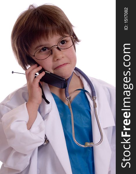 Adorable girl wearing lab coat with a stethoscope around her neck talking on a cell phone. Isolated against a white backdrop. Adorable girl wearing lab coat with a stethoscope around her neck talking on a cell phone. Isolated against a white backdrop.