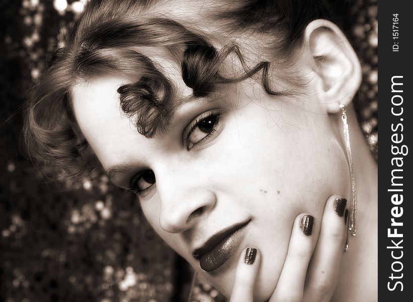 Beautiful young girl with a shimmery backdrop. Sepia toned. Beautiful young girl with a shimmery backdrop. Sepia toned.