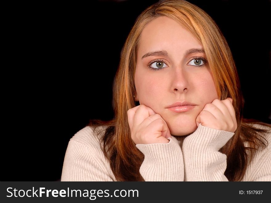 Young woman posing with her hands on her chin