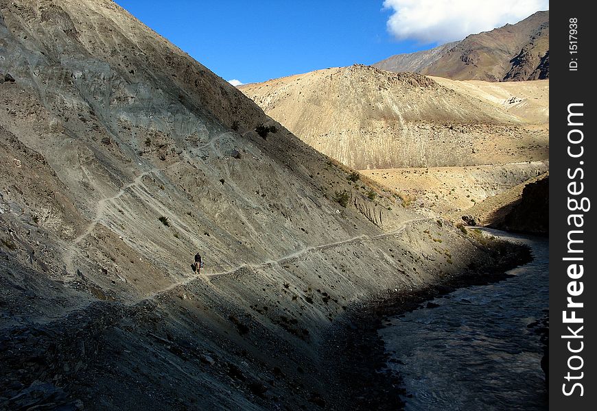 Horseman riding on a path, zanskar valley, Ladakh, India.