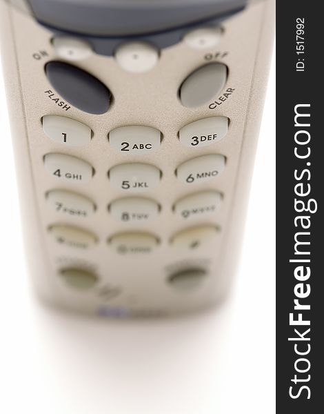 Cordless telephone on white background with shallow focus. Cordless telephone on white background with shallow focus.