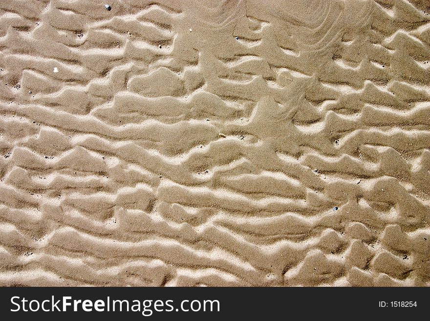 Patterns in the sand created by waves. Patterns in the sand created by waves