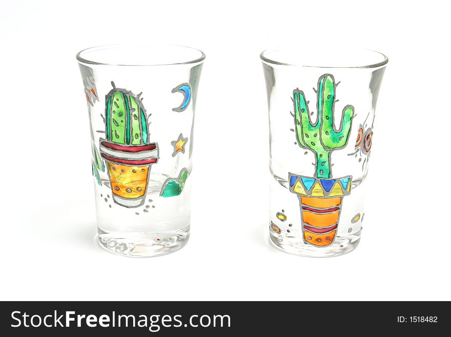 Shooter glasses with cactus painted on them over white backdrop. Shooter glasses with cactus painted on them over white backdrop