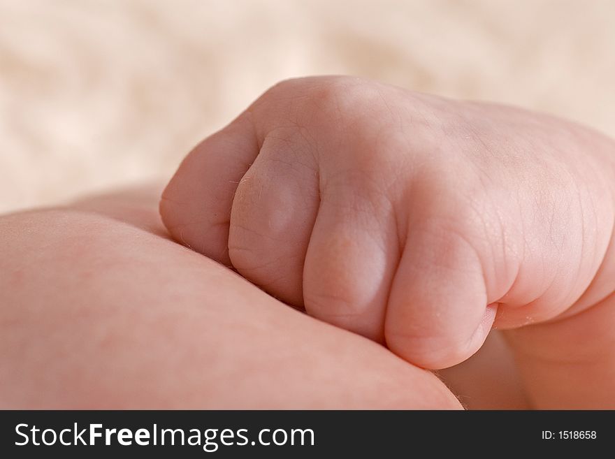 Close up of baby hand resting on chest