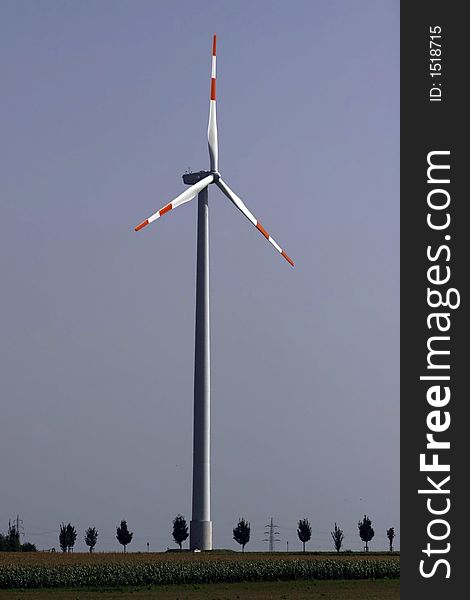 Tall, modern windmill using the wind to generate energy. Tall, modern windmill using the wind to generate energy.