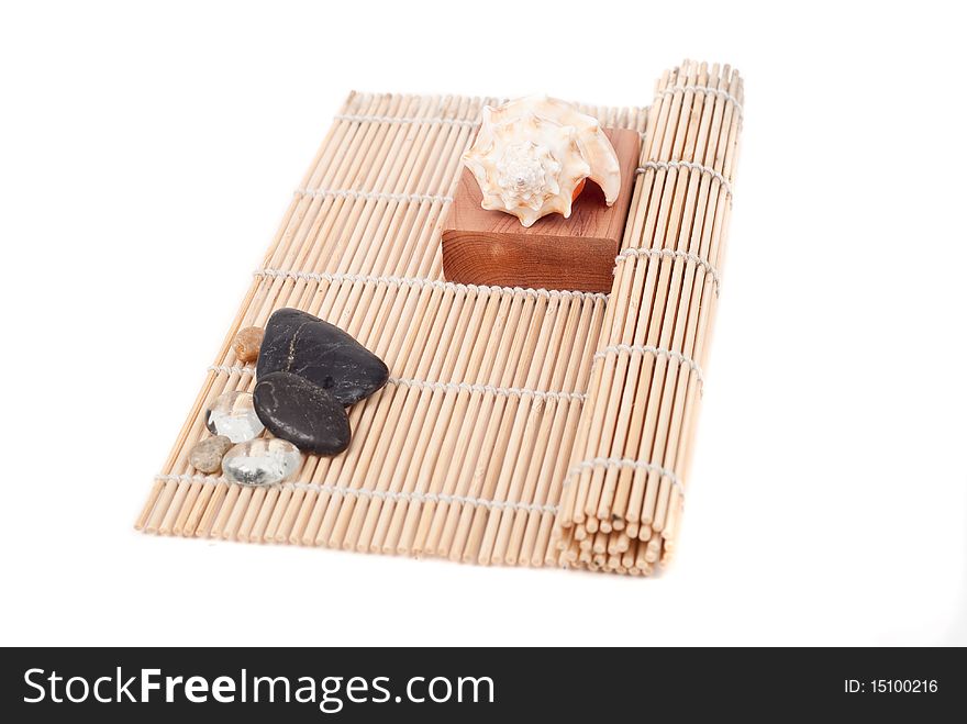 Shell on Wood Block On Top of Sushi Roller. Shell on Wood Block On Top of Sushi Roller