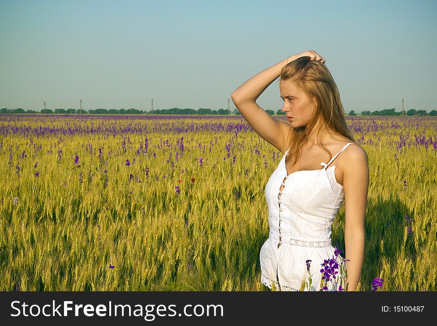 A beautiful woman walks across the field