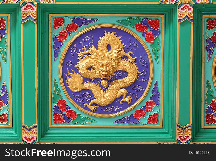 A golden dragon in chinese style. On ceiling.