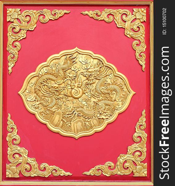 Double golden dragon in chinese style. On red wood.