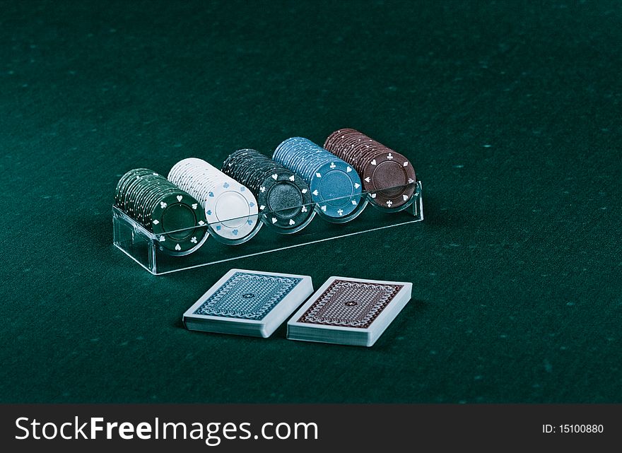 Casino gambling chips on green table. Casino gambling chips on green table