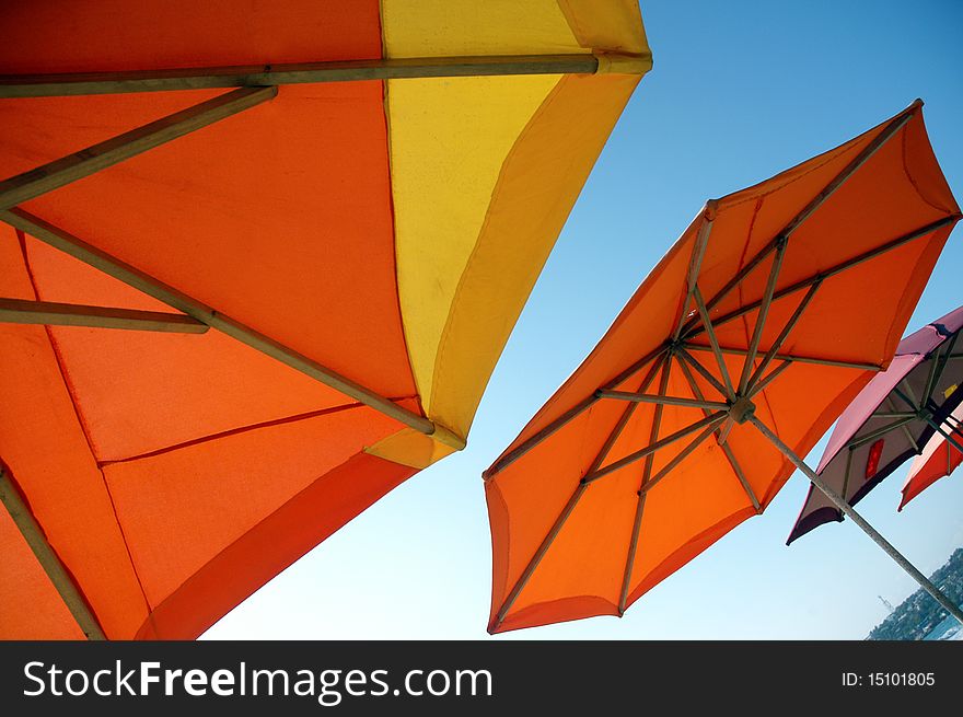 Colorful beach umbrellas on the sunny beach of Puerto Escondido