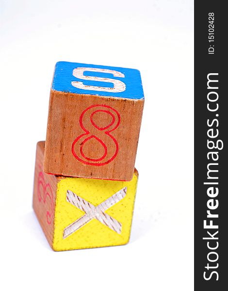 Two childrens wooden blocks showing the number 8 and the letter X. Two childrens wooden blocks showing the number 8 and the letter X