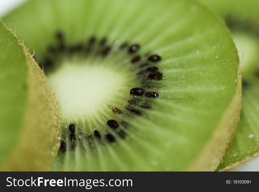 Macro of sliced kiwi spread out to display color and detail. Macro of sliced kiwi spread out to display color and detail