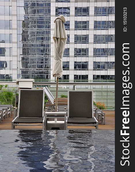 Swimming Chair at swimming pool at the deck of hotel in Thailand