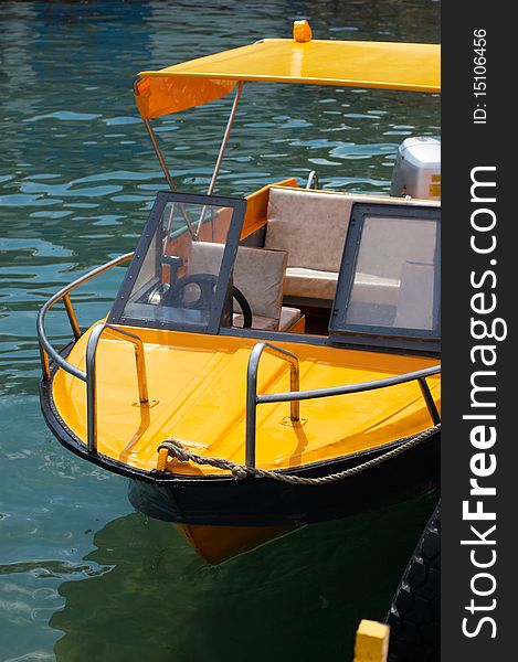 Yellow boat tied up dock