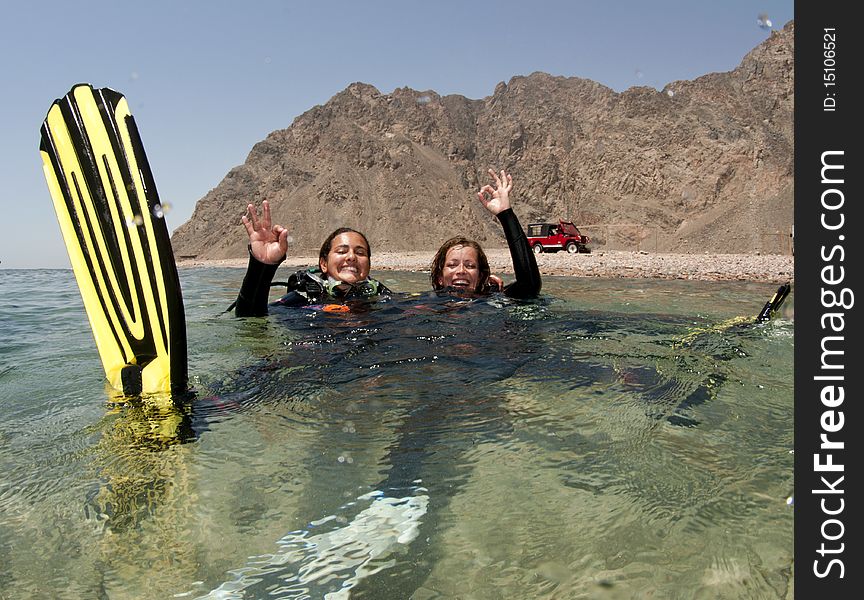 Female Scuba Diver Swimms Backwards On Surface