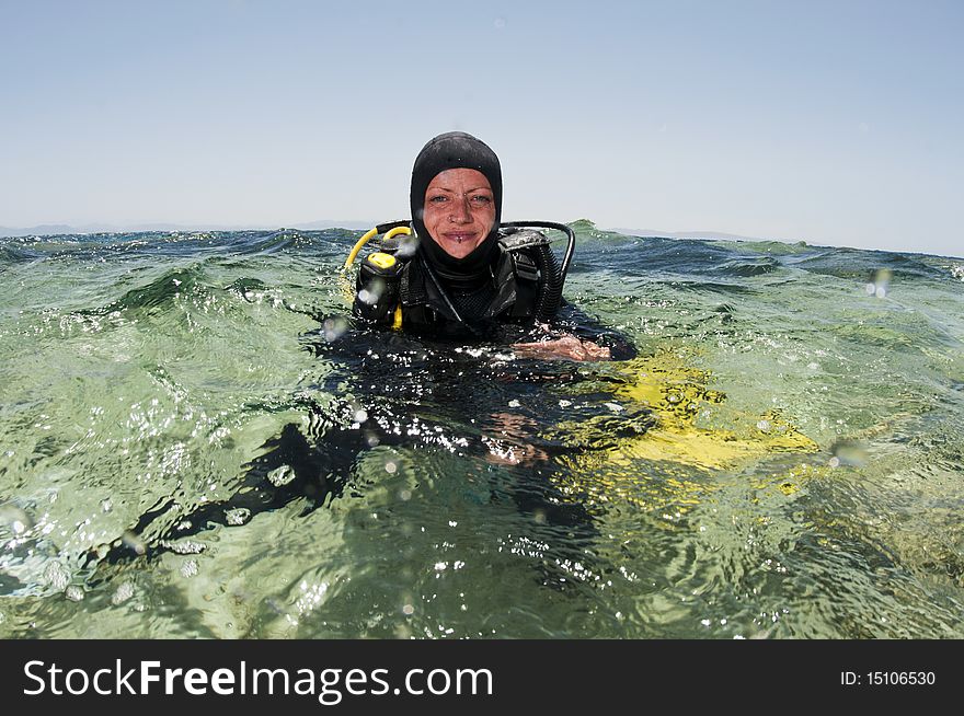 Female scuba diver on surface in red sea