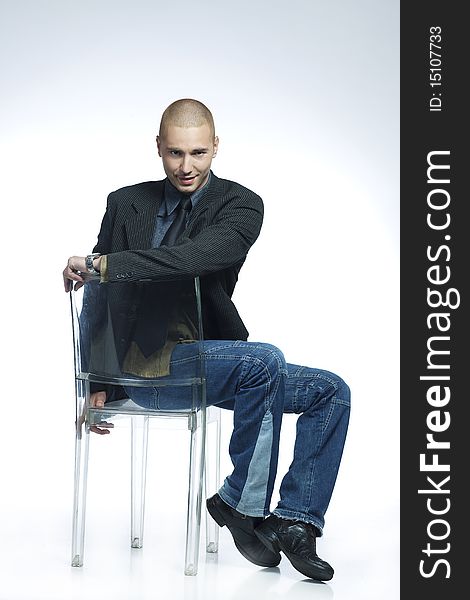 Smiling young male dancer sitting on a chair. Smiling young male dancer sitting on a chair