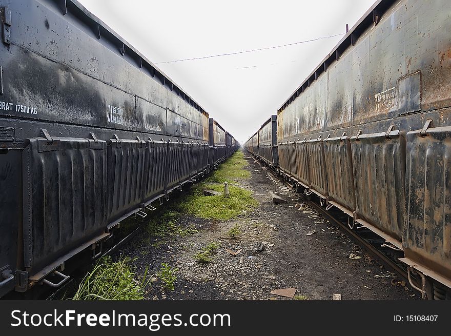 Black iron train car, parking on train depot